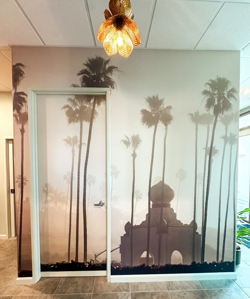 Amaya Wellness Spa interior featuring palm tree mural and lotus light fixture
